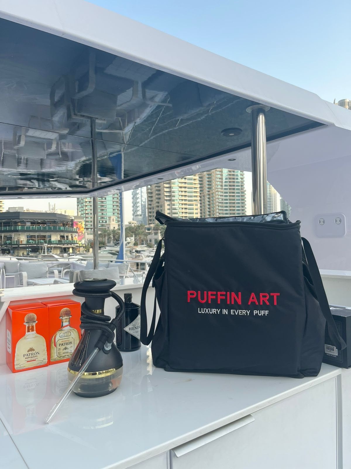 Electric shisha with Puffin Art Delivery bag on the table of the Yacht in Dubai